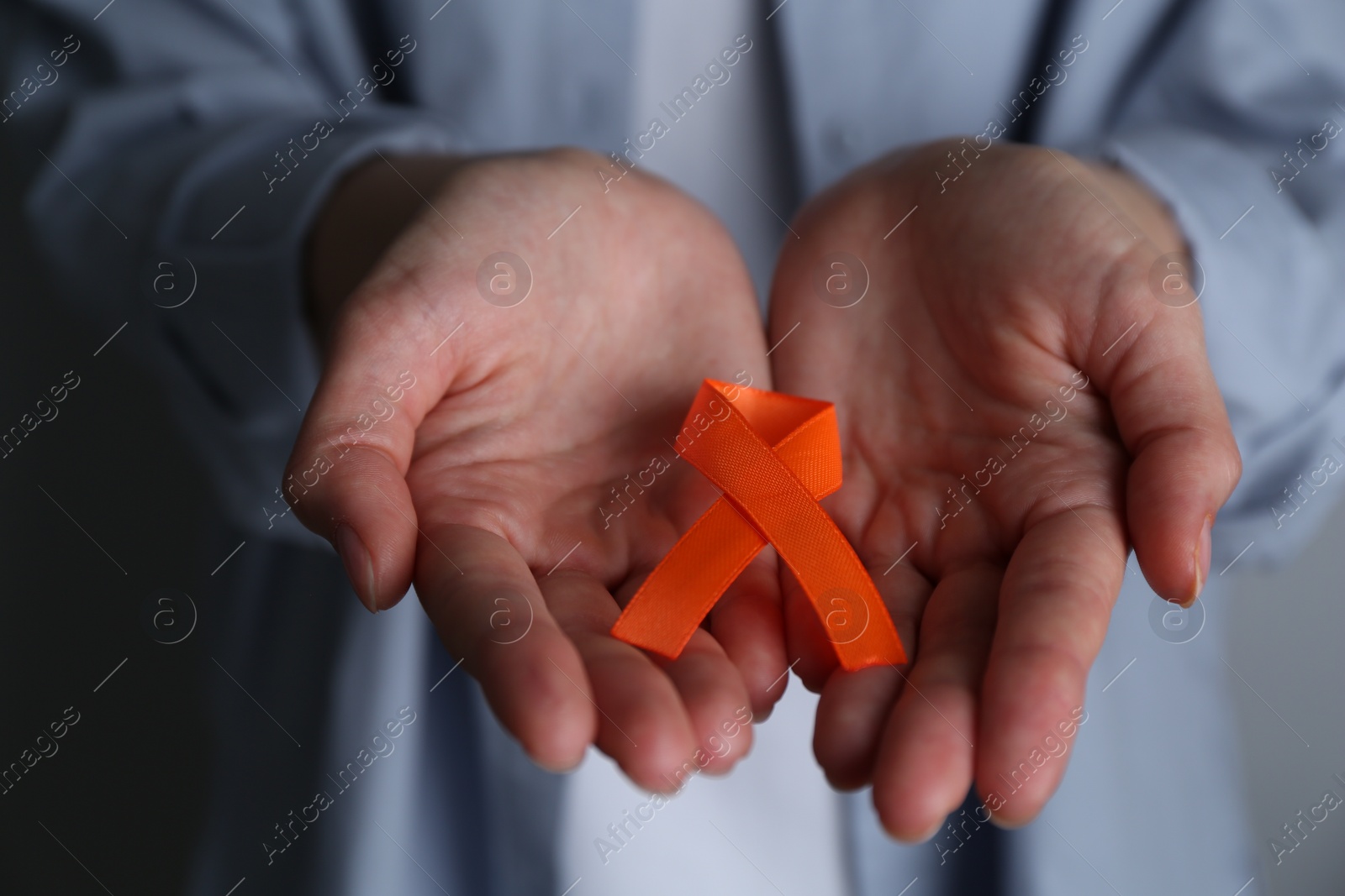 Photo of Woman with orange awareness ribbon, closeup view