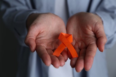 Woman with orange awareness ribbon, closeup view