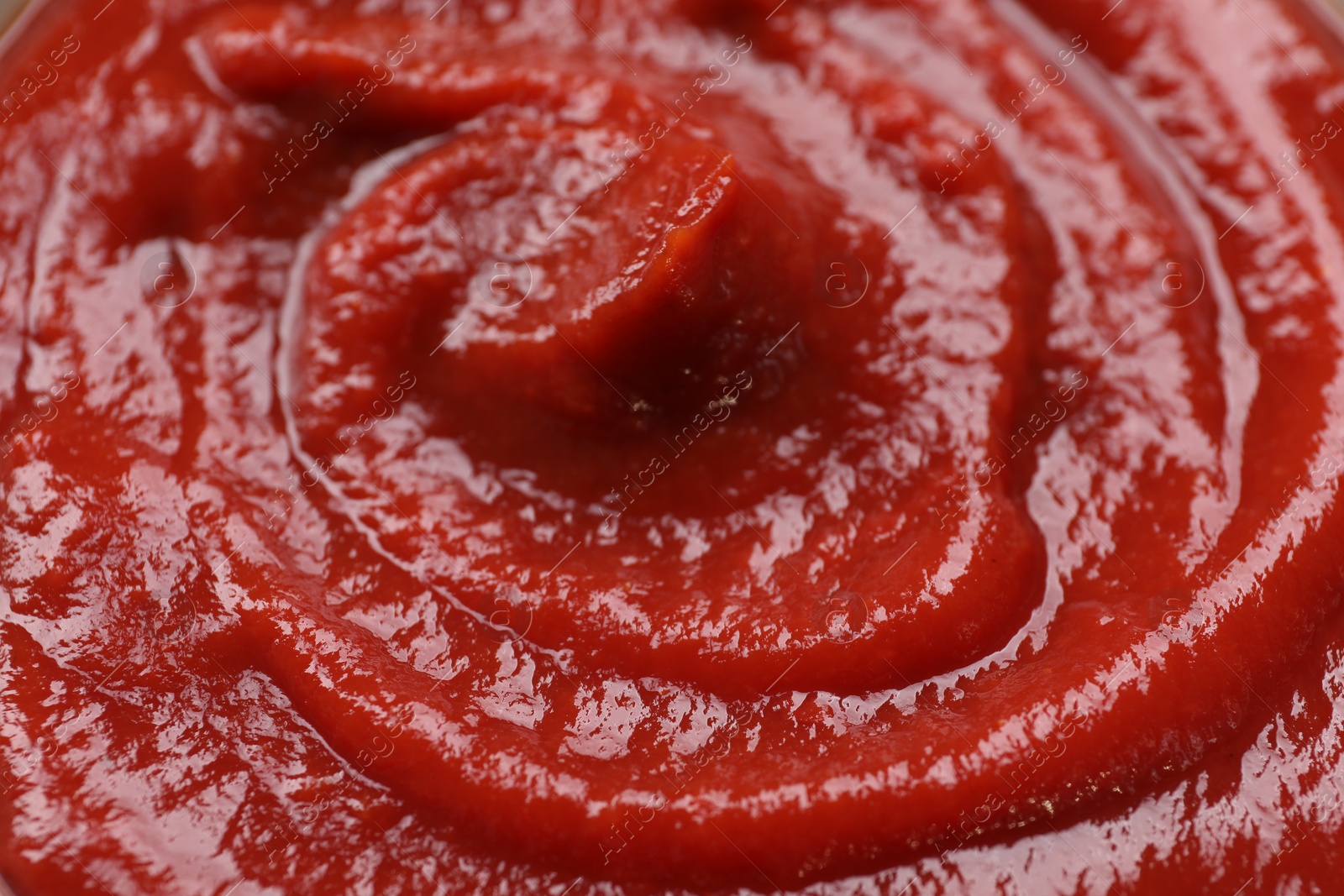 Photo of Organic ketchup as background, closeup. Tomato sauce