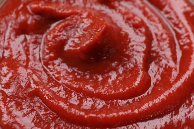 Organic ketchup as background, closeup. Tomato sauce