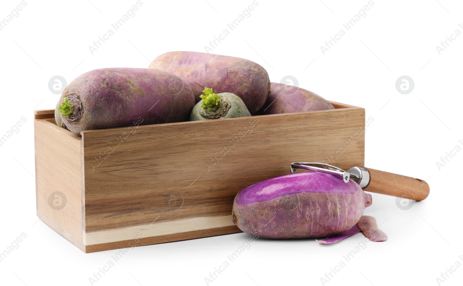 Photo of Daikon radishes in wooden crate and peeler isolated on white