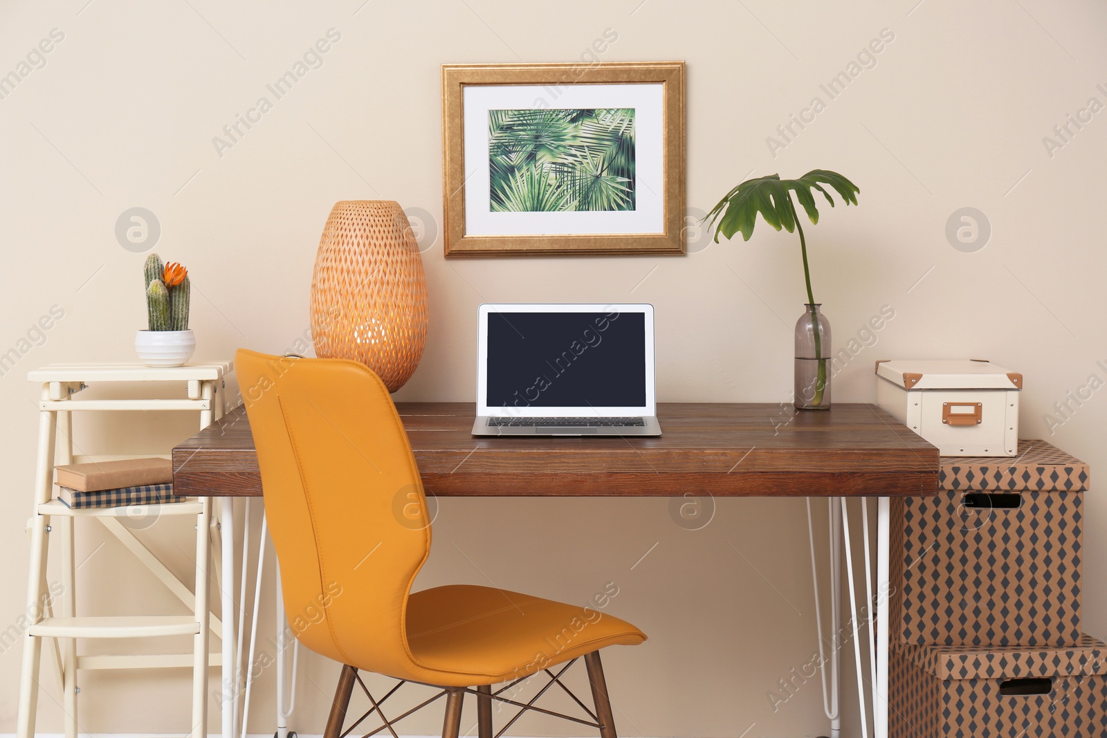 Photo of Stylish workplace with laptop on table in office