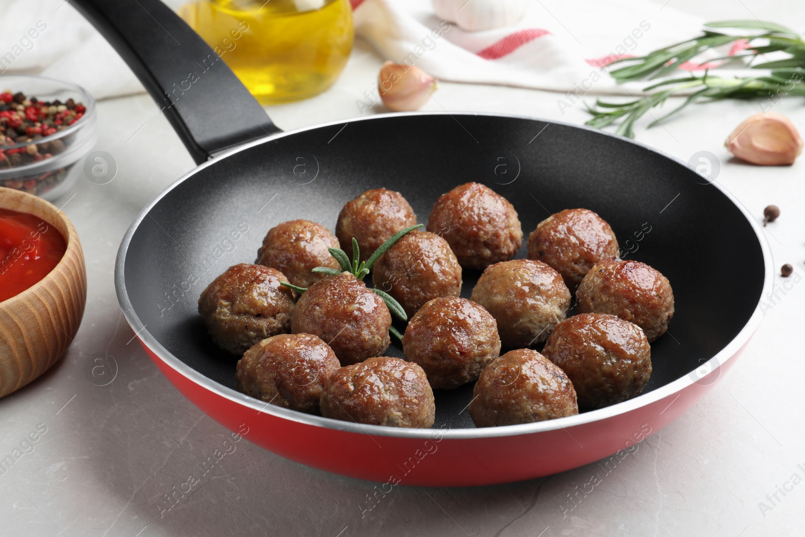 Photo of Tasty cooked meatballs on light grey marble table