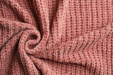 Beautiful pink knitted fabric as background, top view