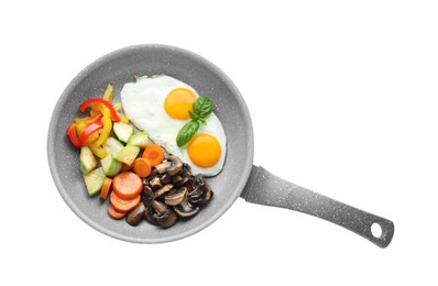 Tasty fried eggs with vegetables in pan isolated on white, top view