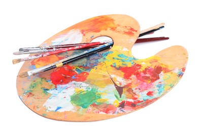 Palette with paints and brushes on white background. Artist equipment