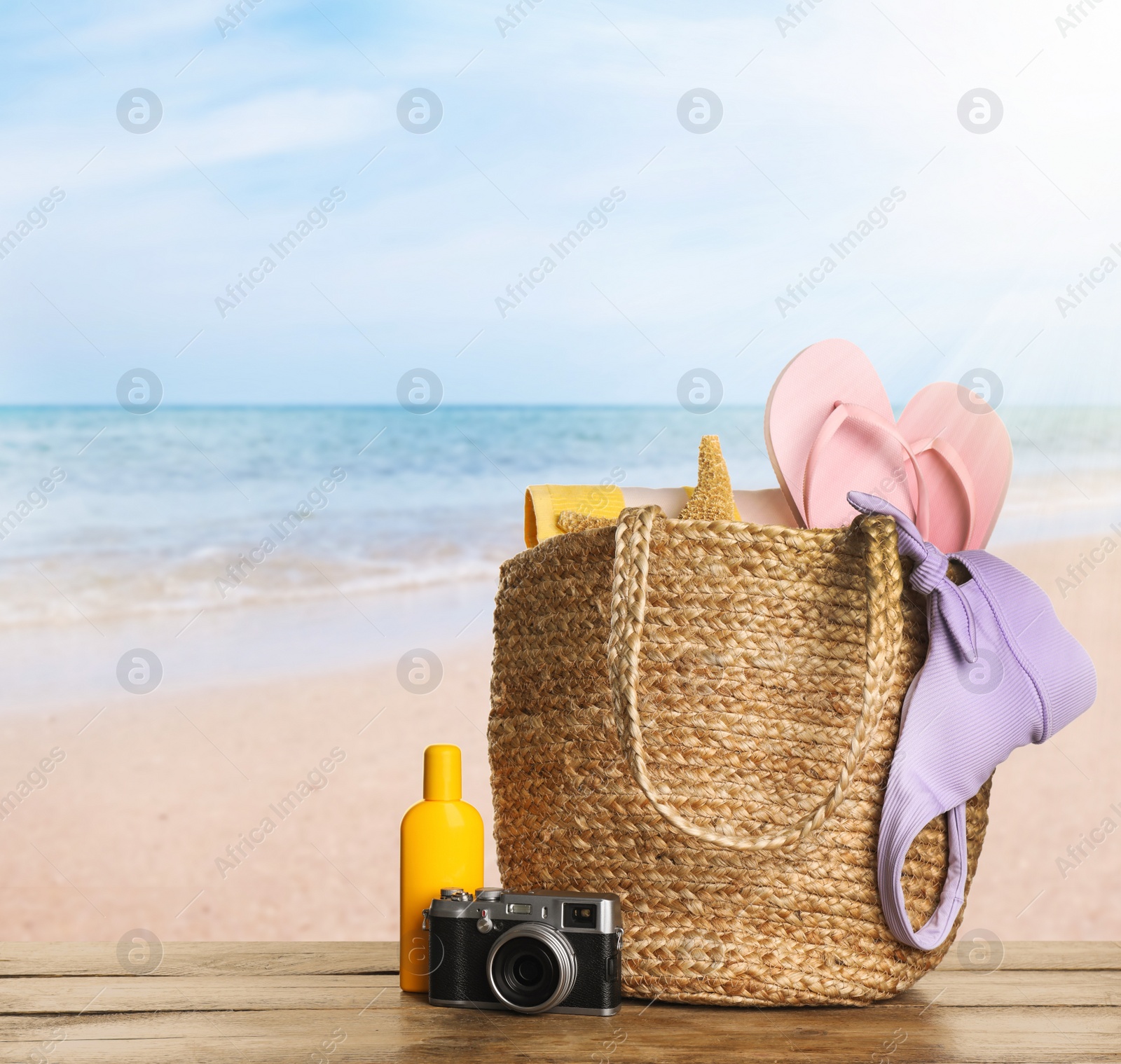 Image of Different beach objects on wooden surface near sea