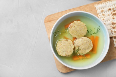 Photo of Flat lay composition with Jewish matzoh balls soup on light table. Space for text