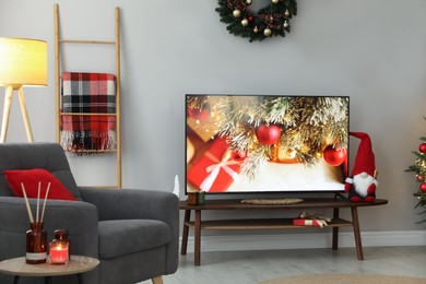 Stylish living room interior with modern TV and Christmas decor