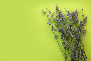 Photo of Beautiful lavender flowers on light green background, flat lay. Space for text