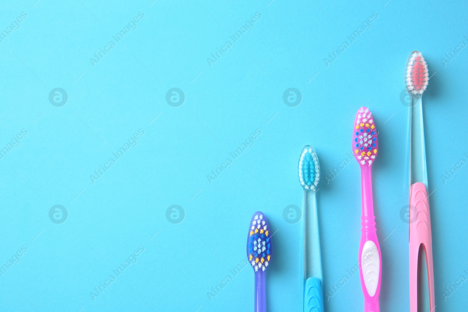 Photo of Flat lay composition with manual toothbrushes on color background