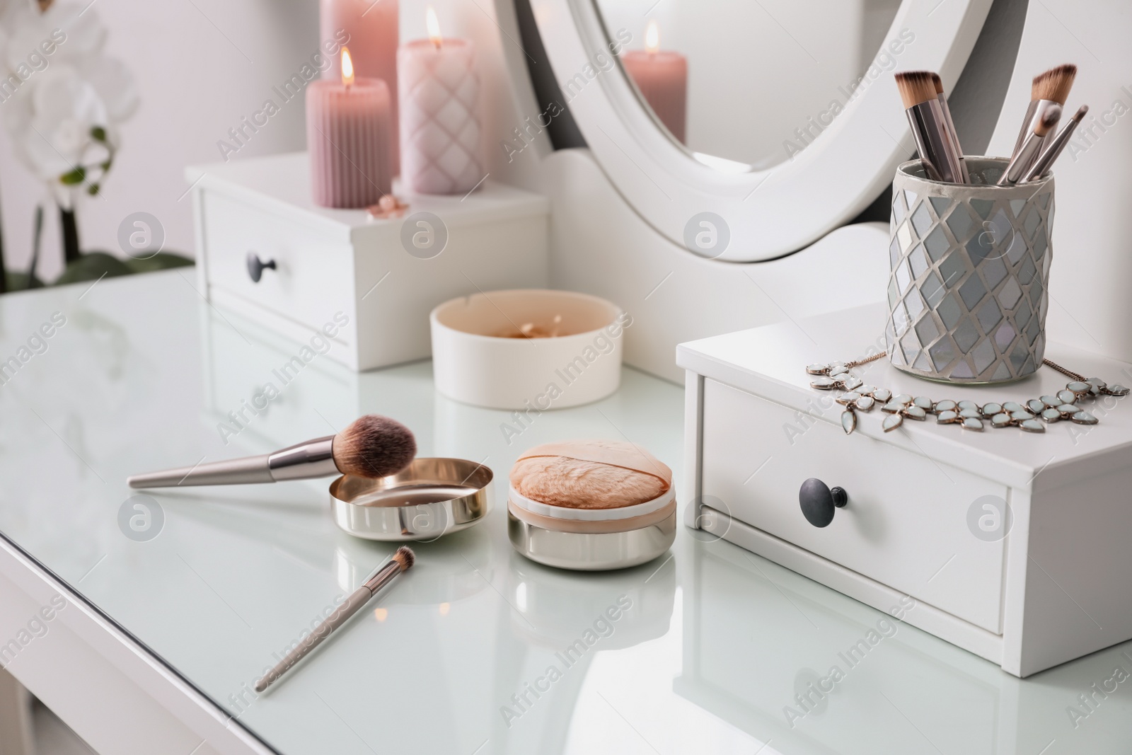 Photo of Wooden dressing table with decorative elements and makeup products in room