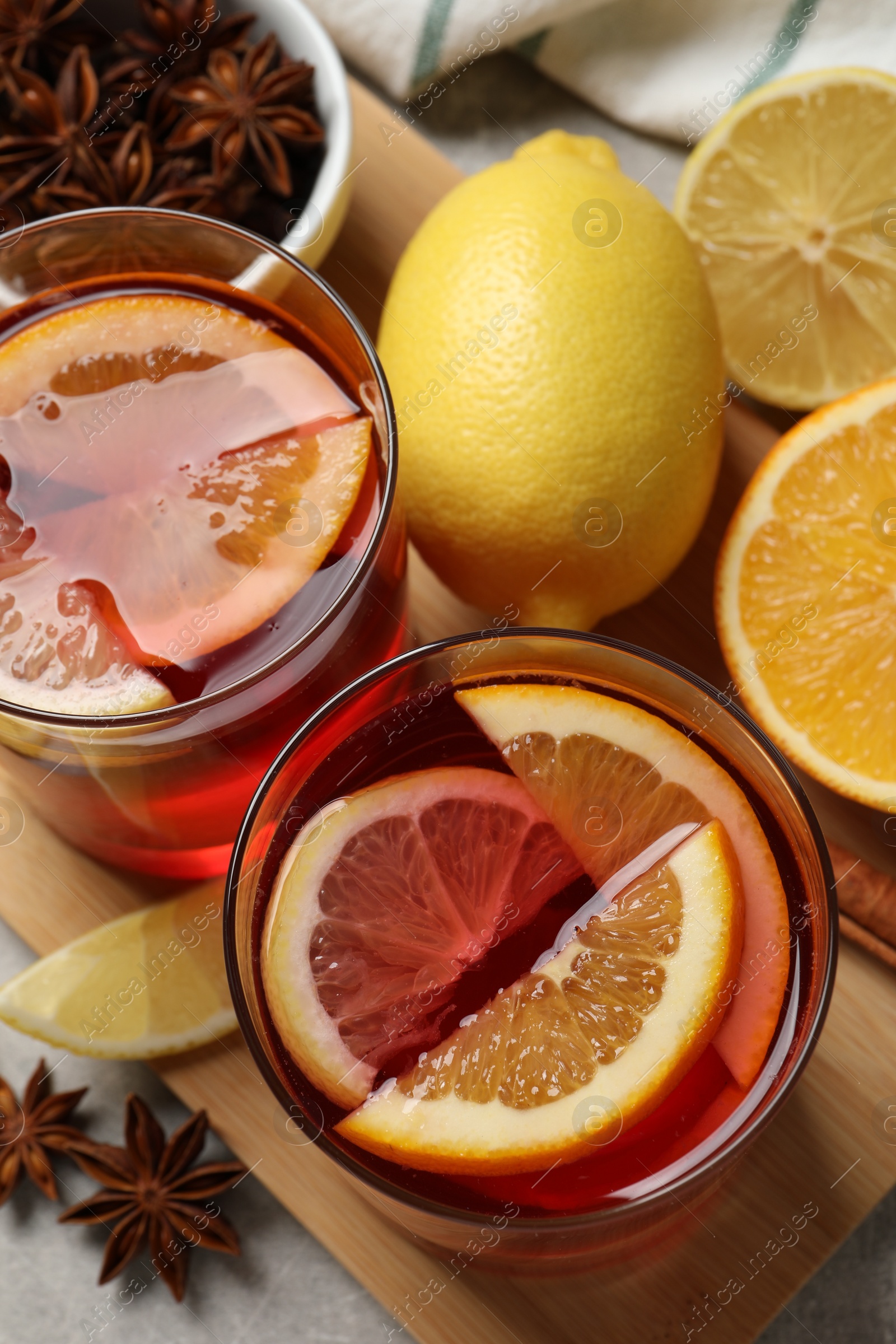 Photo of Aromatic punch drink and ingredients on table, flat lay