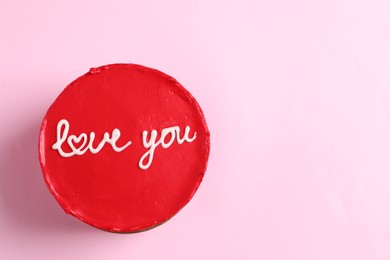 Photo of Bento cake with text Love You and space for text on pink table, top view. St. Valentine's day surprise