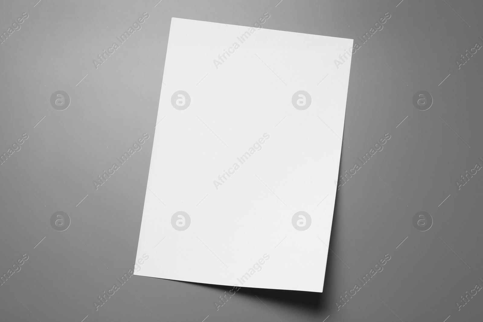 Photo of Blank paper sheets for brochure on grey background, top view. Mock up