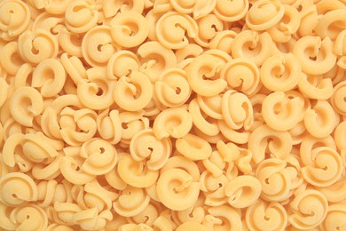 Photo of Raw dischi volanti pasta as background, top view