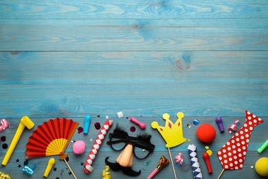 Photo of Flat lay composition with carnival items on light blue wooden background. Space for text