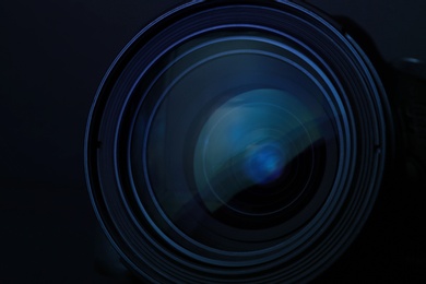 Photo of Lens of professional camera on black background, closeup