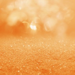 Image of Shiny orange glitter and blurred lights on background. Bokeh effect