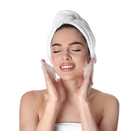 Young woman washing face with soap on white background