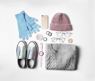 Stylish female autumn outfit and accessories on white background, flat lay. Trendy warm clothes