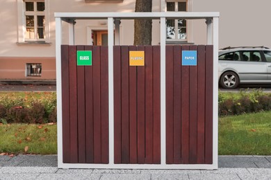 Different sorting bins for waste recycling on city street outdoors