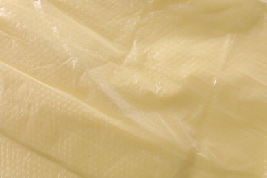 Texture of yellow plastic bag as background, closeup