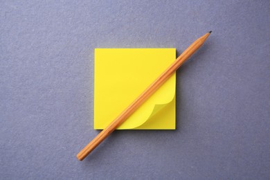 Photo of Blank paper note and pencil on color background, top view