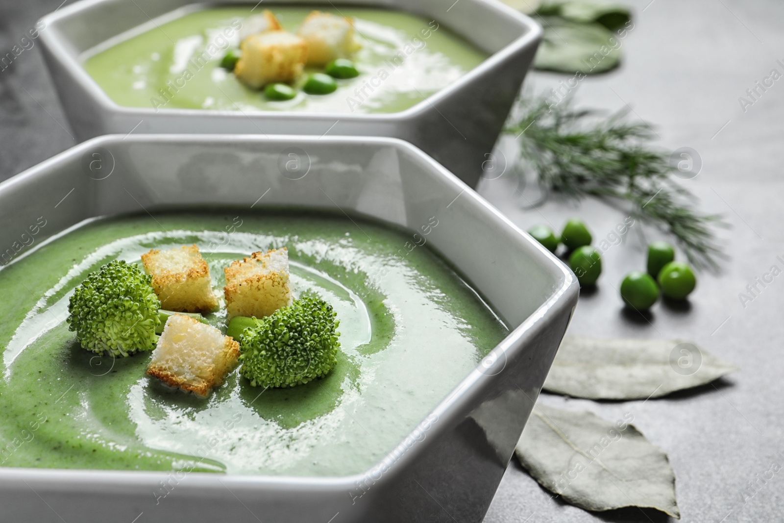 Photo of Fresh vegetable detox soup made of broccoli with croutons on table