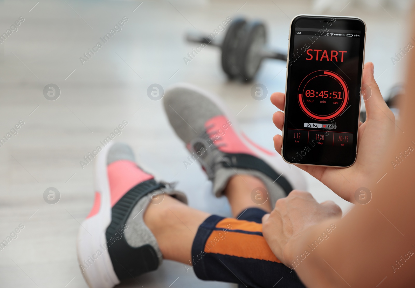 Photo of Young woman using fitness app on smartphone indoors, closeup. Space for text