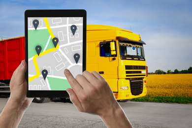 Image of Logistics concept. Man using tablet with map on screen against truck