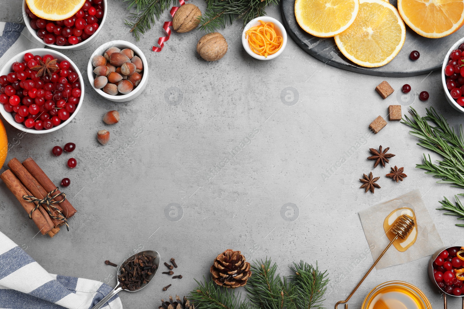 Photo of Flat lay composition with fresh ripe cranberries on grey table. Space for text