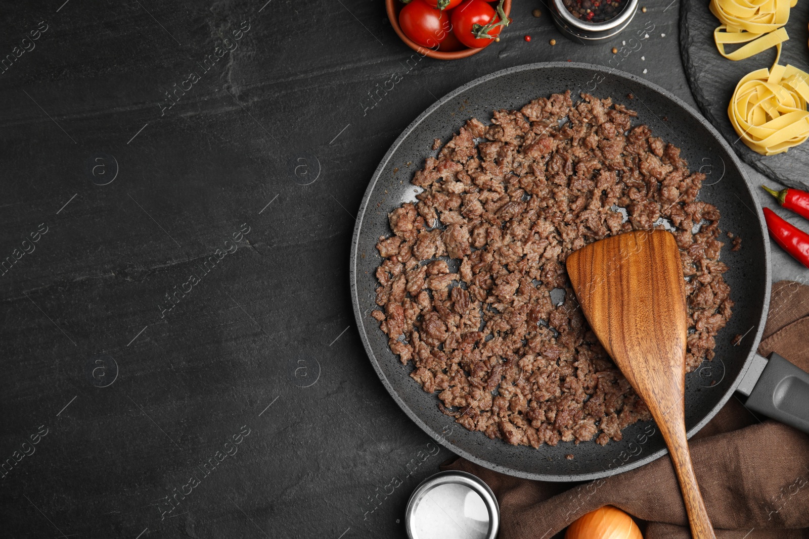 Photo of Fried minced meat served on black table, flat lay. Space for text