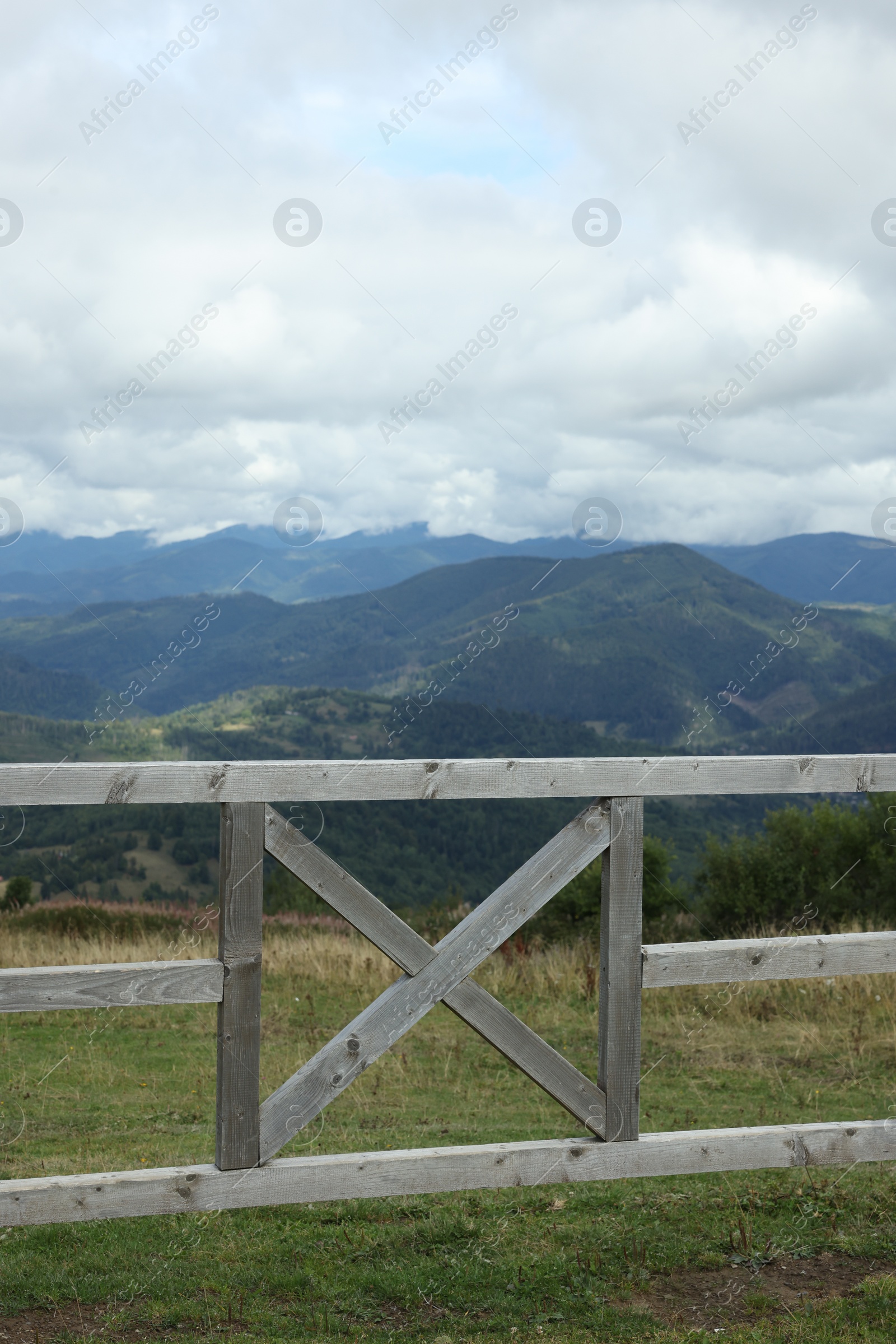 Photo of Wooden fence and picturesque view of mountain landscape