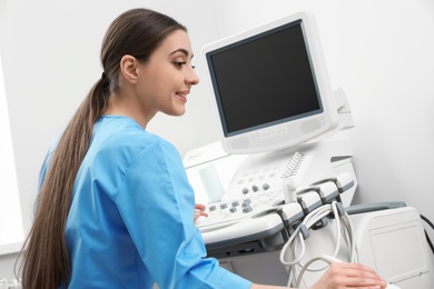 Photo of Sonographer operating modern ultrasound machine in clinic