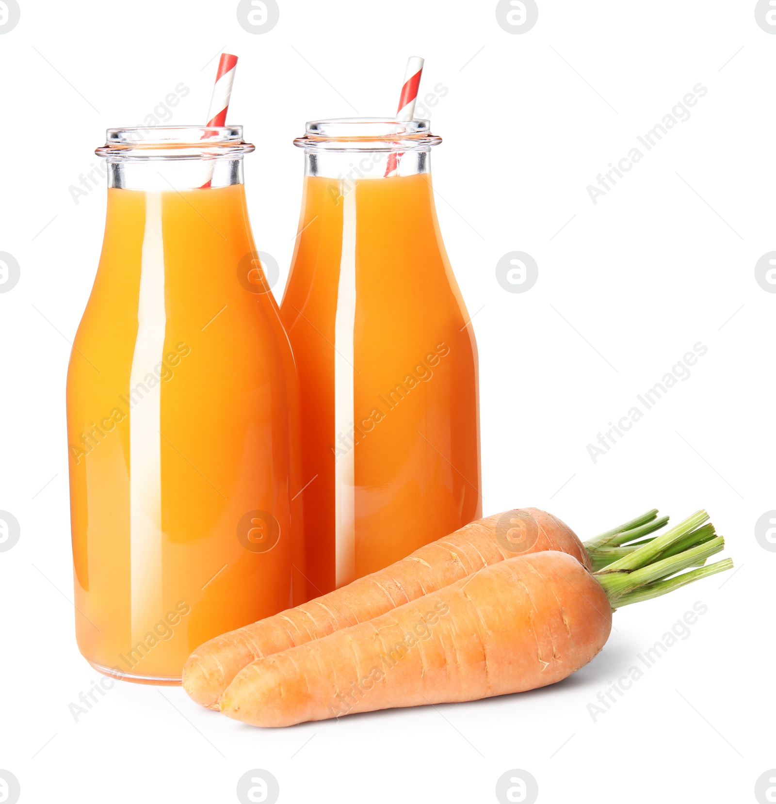 Photo of Freshly made carrot juice in glass bottles on white background