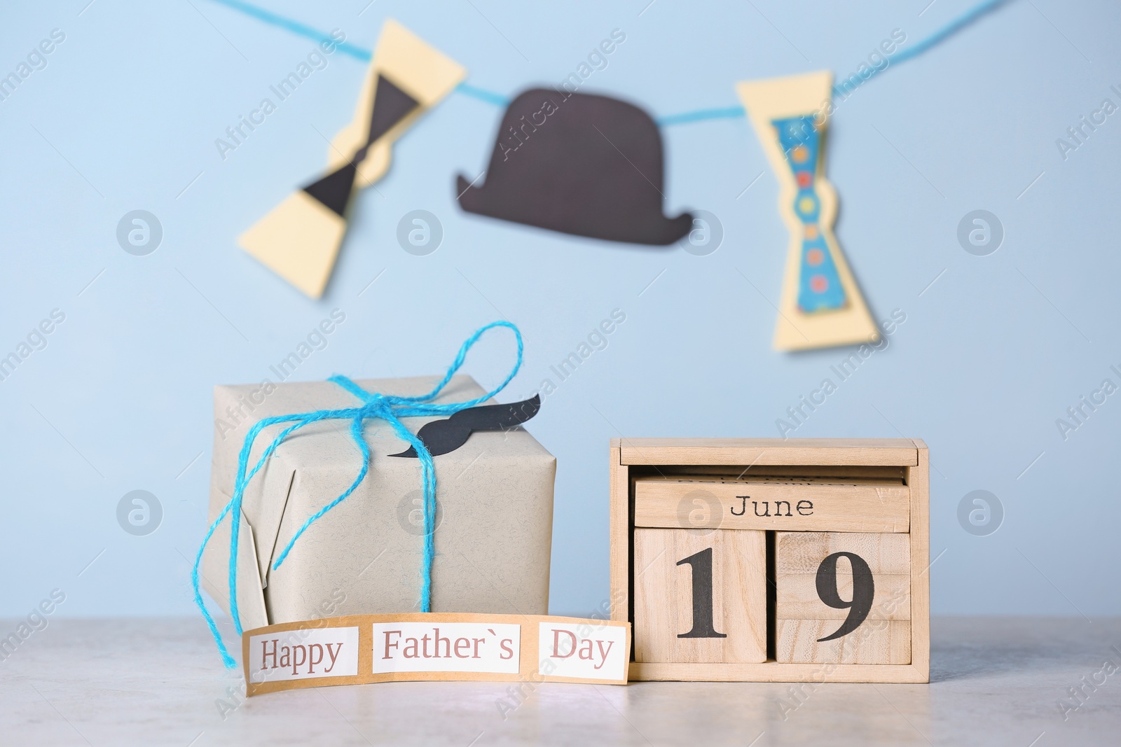 Photo of Calendar with date and gift box on table. Father's day celebration