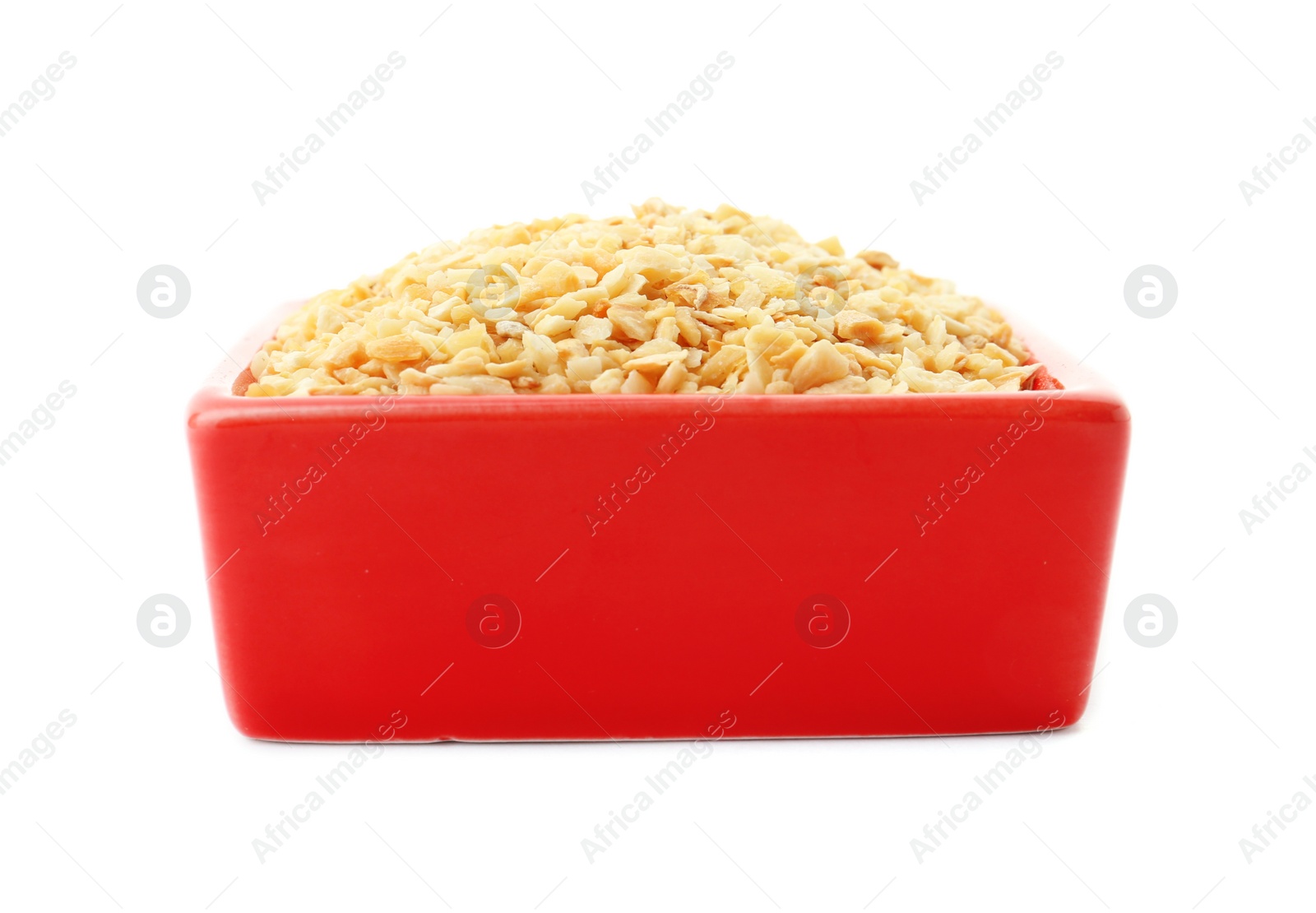 Photo of Bowl of granulated dry garlic on white background