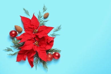 Flat lay composition with poinsettia and space for text on color background. Traditional Christmas flower