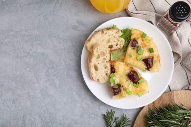 Photo of Tasty sausage casserole served on grey table, flat lay. Space for text