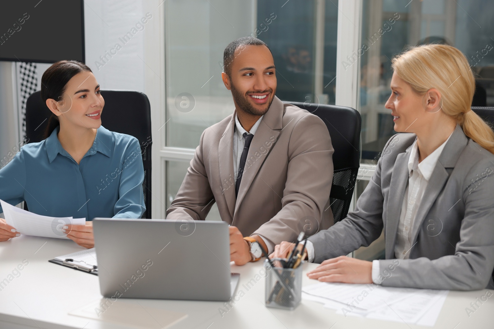 Photo of Lawyers working together at table in office