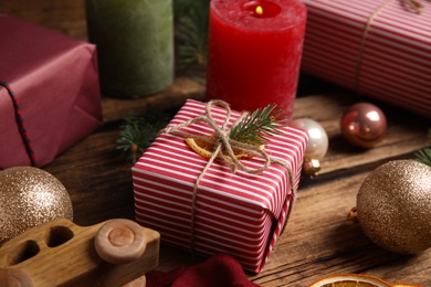 Photo of Composition with beautifully wrapped gift box on wooden table