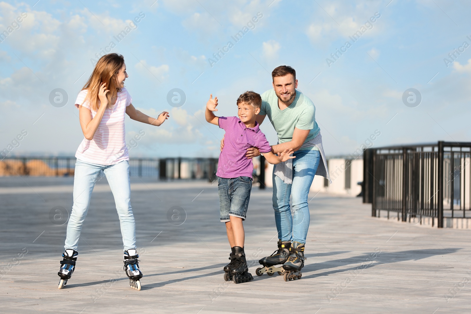 Photo of Happy family roller skating on city street