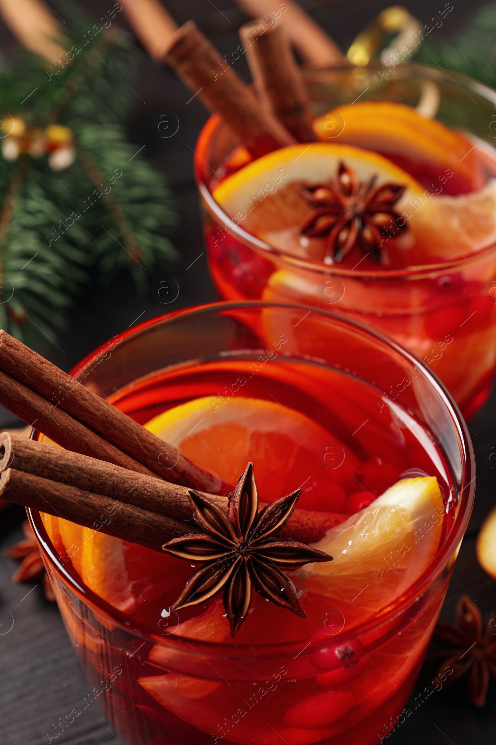 Photo of Glass with delicious punch drink on wooden table, closeup