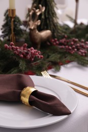 Beautiful festive place setting with Christmas decor on table