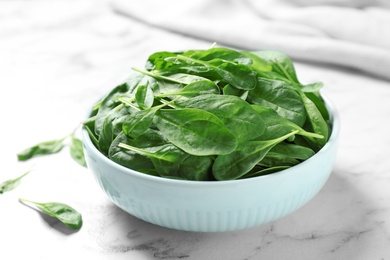 Fresh green healthy spinach on white marble table