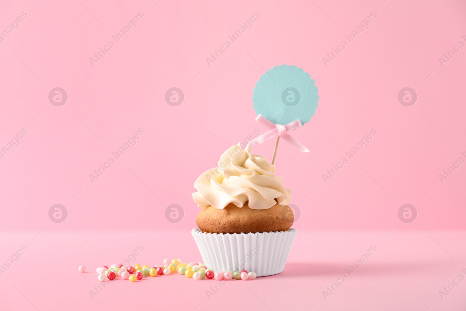 Photo of Delicious birthday cupcake on color background