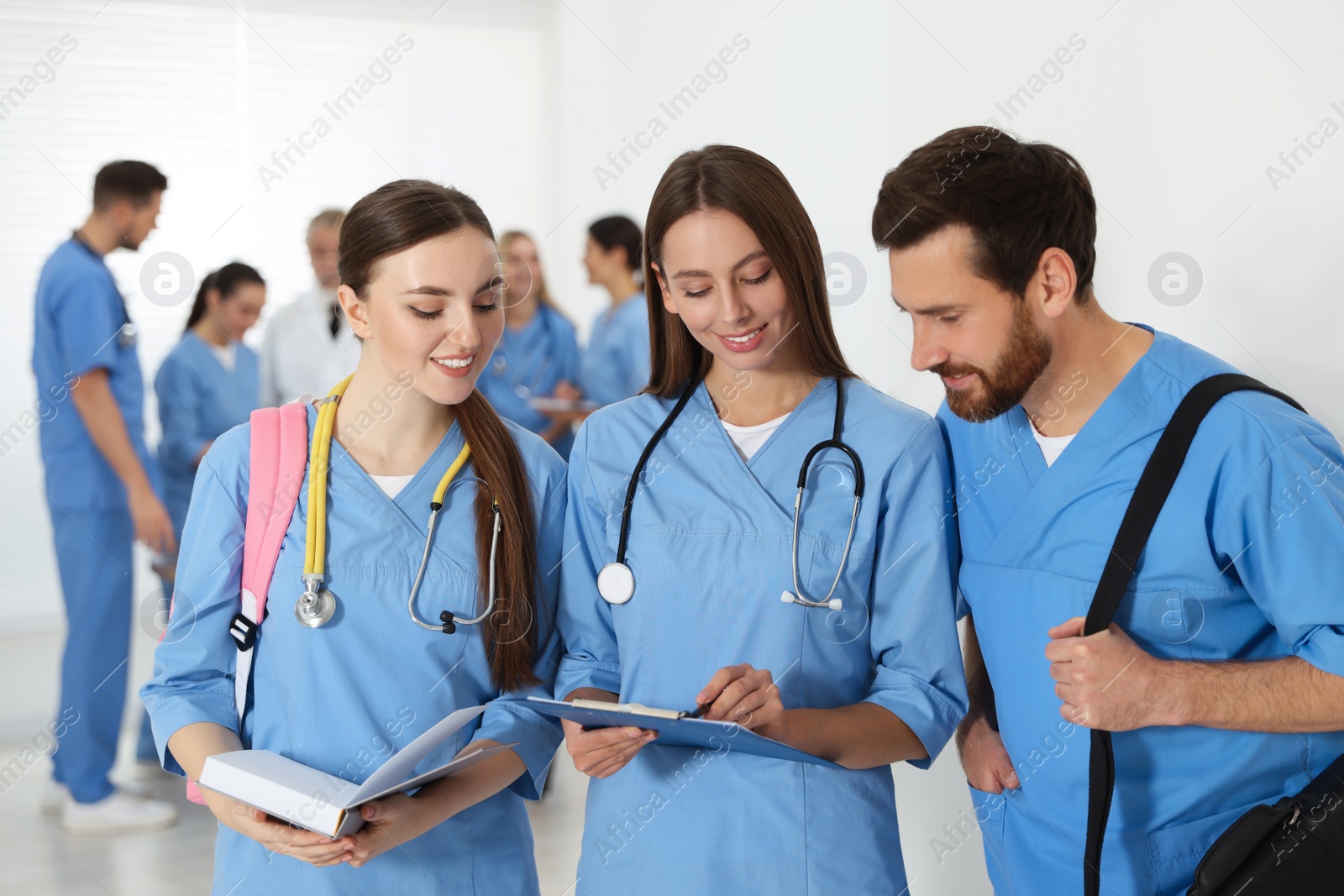 Photo of Medical students wearing uniforms in university hallway