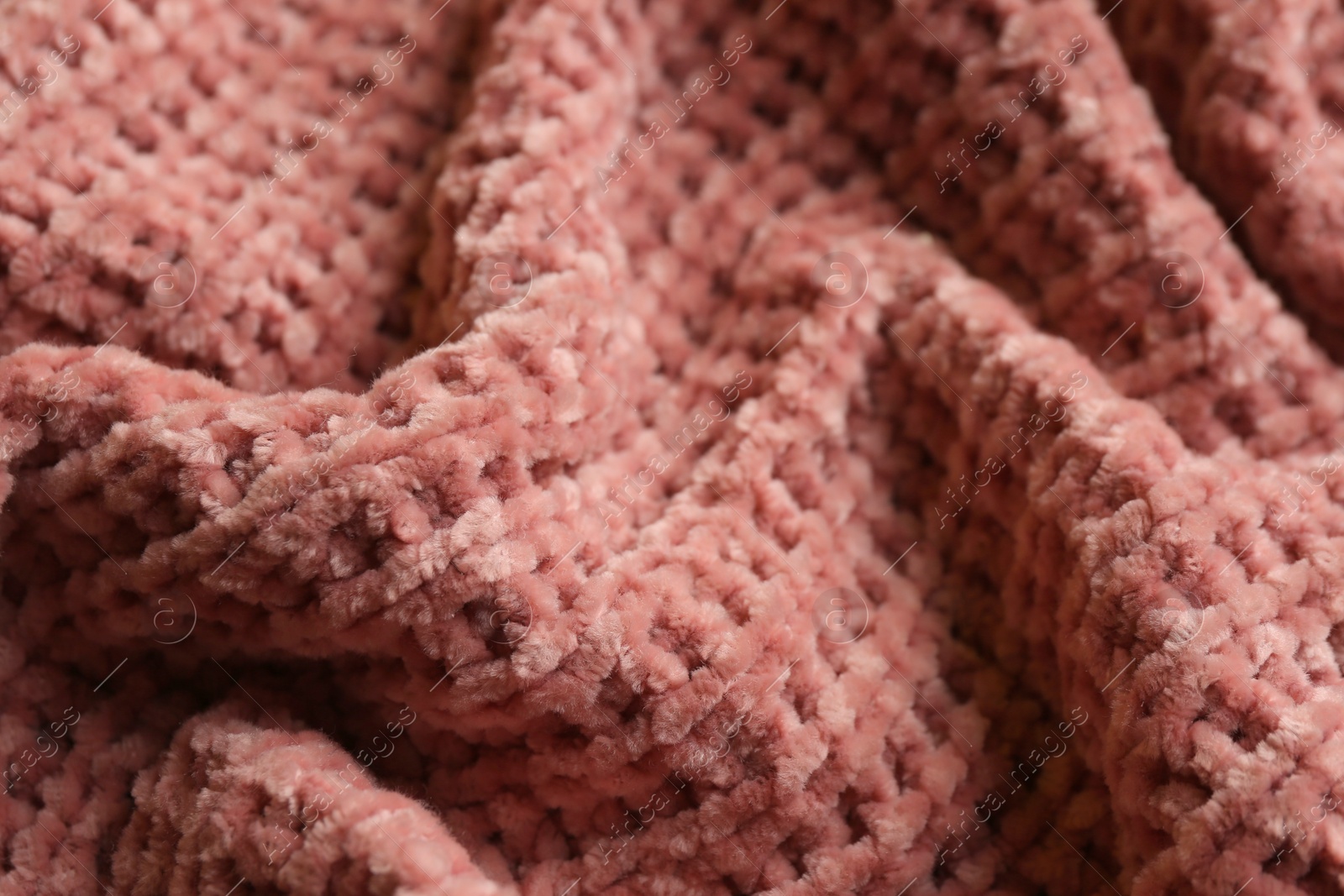 Photo of Beautiful pink knitted fabric as background, closeup