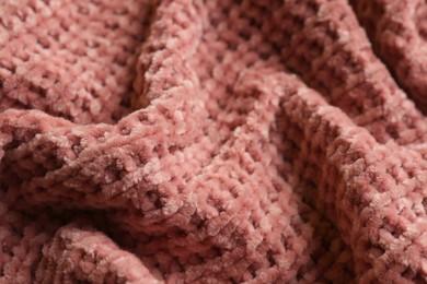 Beautiful pink knitted fabric as background, closeup